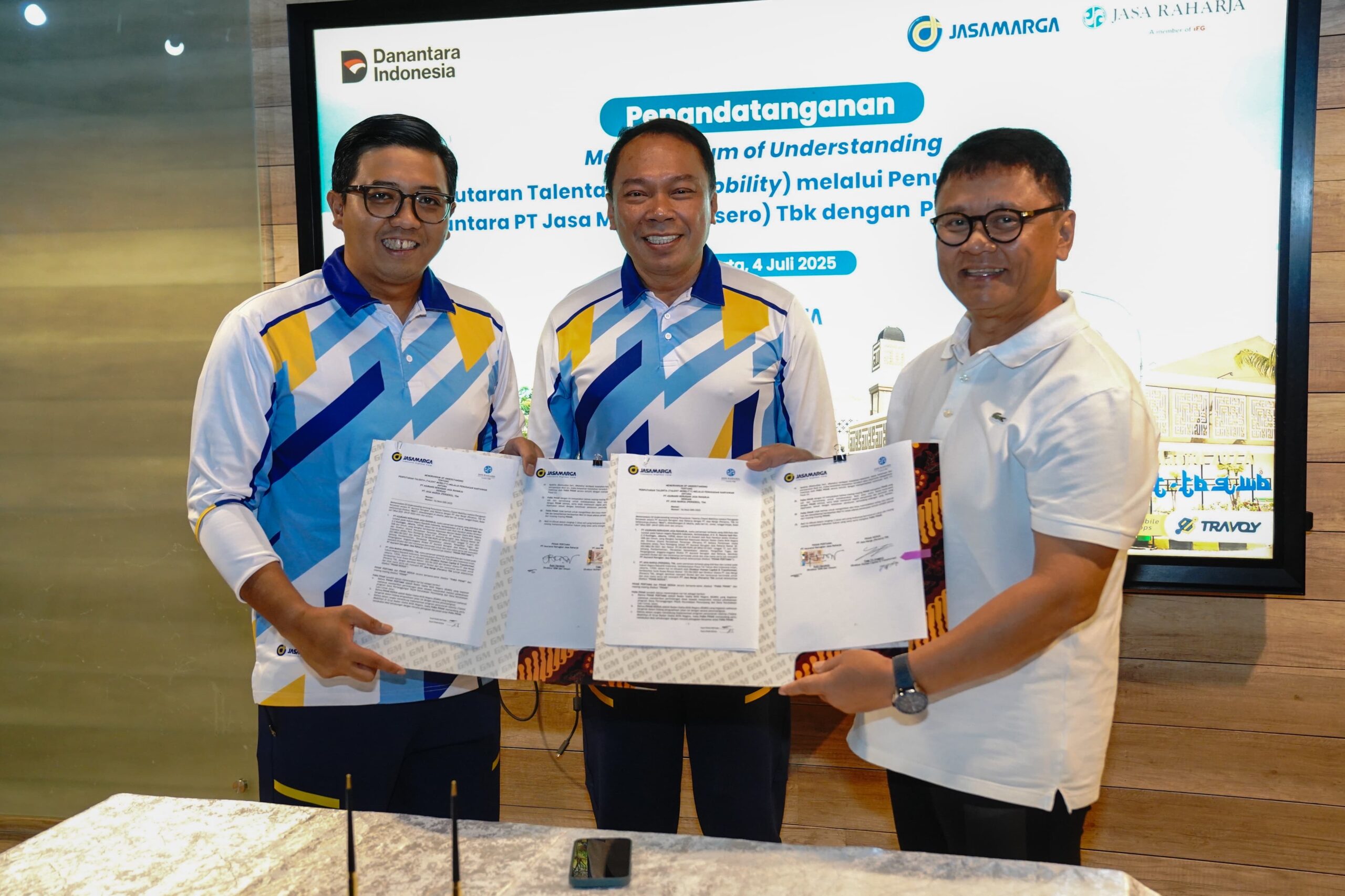 Pihak jasamarga dan pihsk Jasa raharja memperlihatkan hasil penandatanganan kedua perusahaan BUMN ( foto: jasamarga)